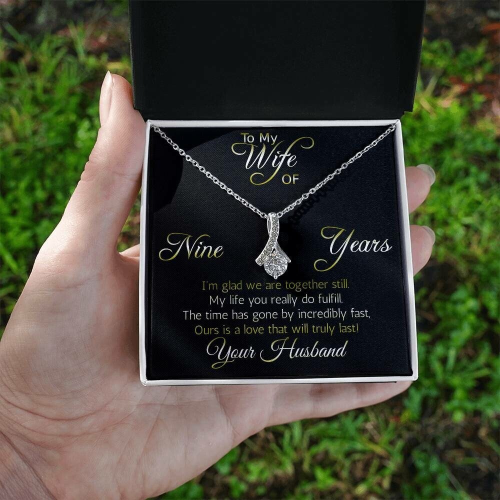 Terrific Nine years' anniversary gift: Alluring Beauty ribbon pendant reminds her that your love is forever!