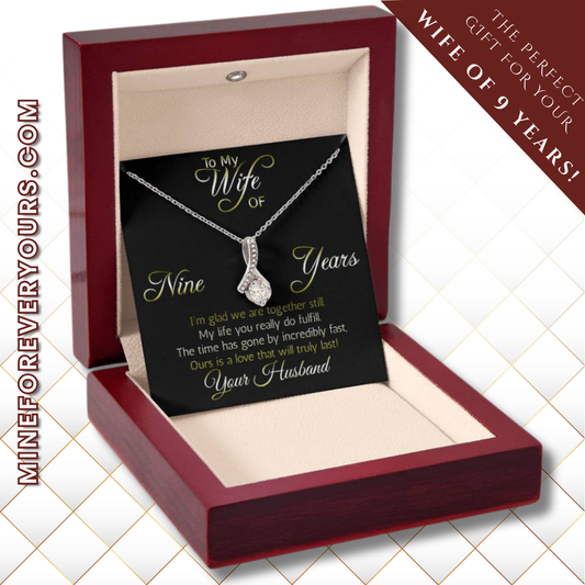 Terrific Nine years' anniversary gift:  Alluring Beauty ribbon pendant reminds her that your love is forever!